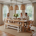 Solid white oak dining bench at a farmhouse dining table with adults seated, pendant lights above in warm evening light