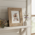 Reclaimed pine picture frame on a farmhouse shelf with dried wildflowers and a family photo